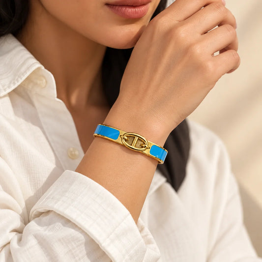 Azure Link stainless steel bangle in blue with a link motif design, worn on a model wrist