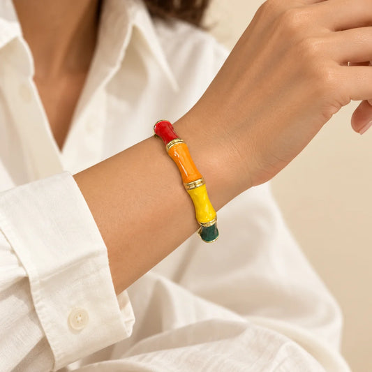 Tropical Bamboo stainless steel bangle in red, orange, yellow with a colour block design, worn on a model wrist