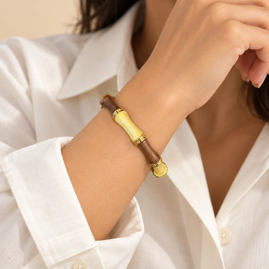Mocha Bamboo stainless steel bangle in brown, ivory with a colour block design, worn on a model wrist