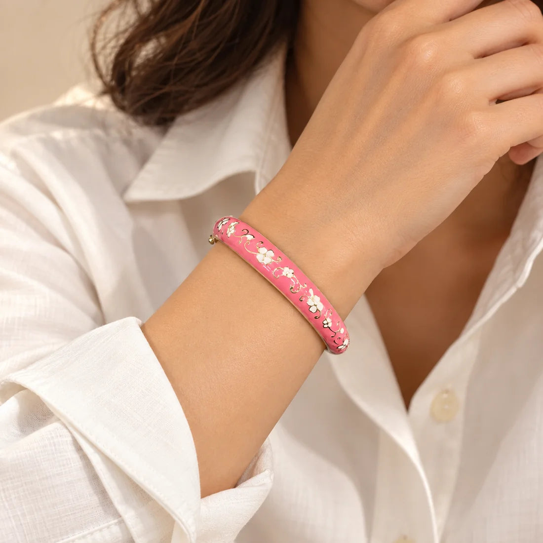 Rose Floral Lace stainless steel bangle in pink, white with a floral design, worn on a model wrist