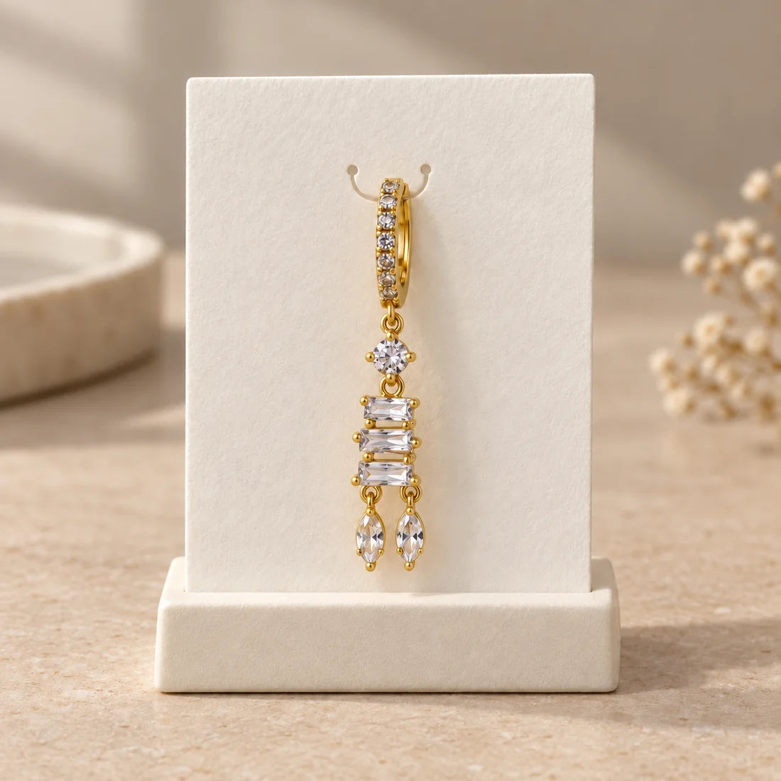 Baguette Cascade Piercing displayed on an ivory jewelry card