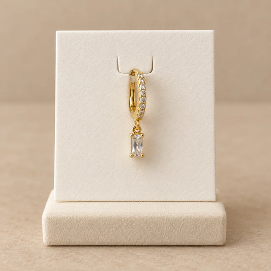 Baguette Drop Piercing displayed on an ivory jewelry card
