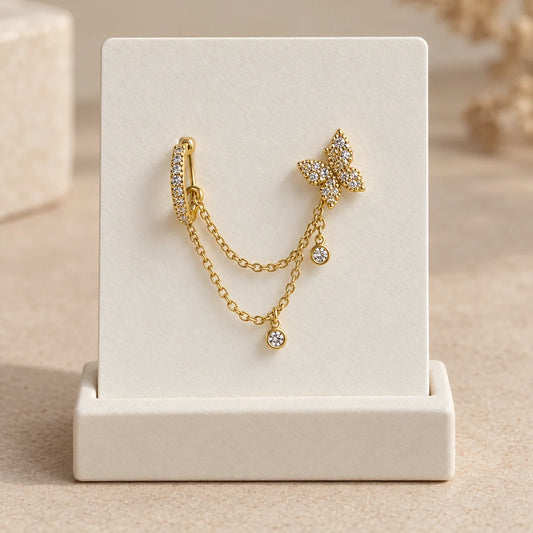 Butterfly Cascade Piercing displayed on an ivory jewelry card