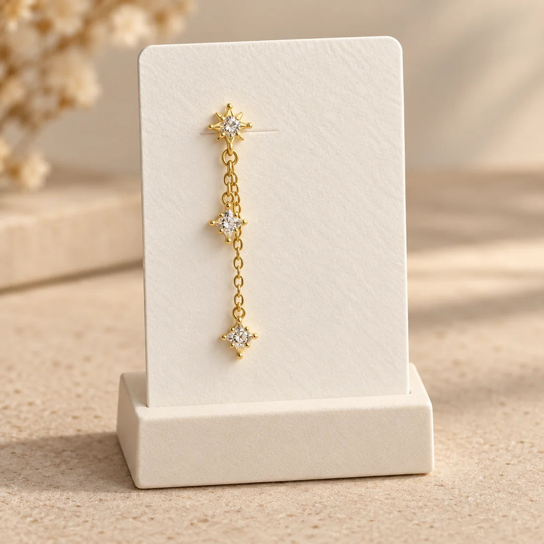 Celestial Trail Piercing displayed on an ivory jewelry card