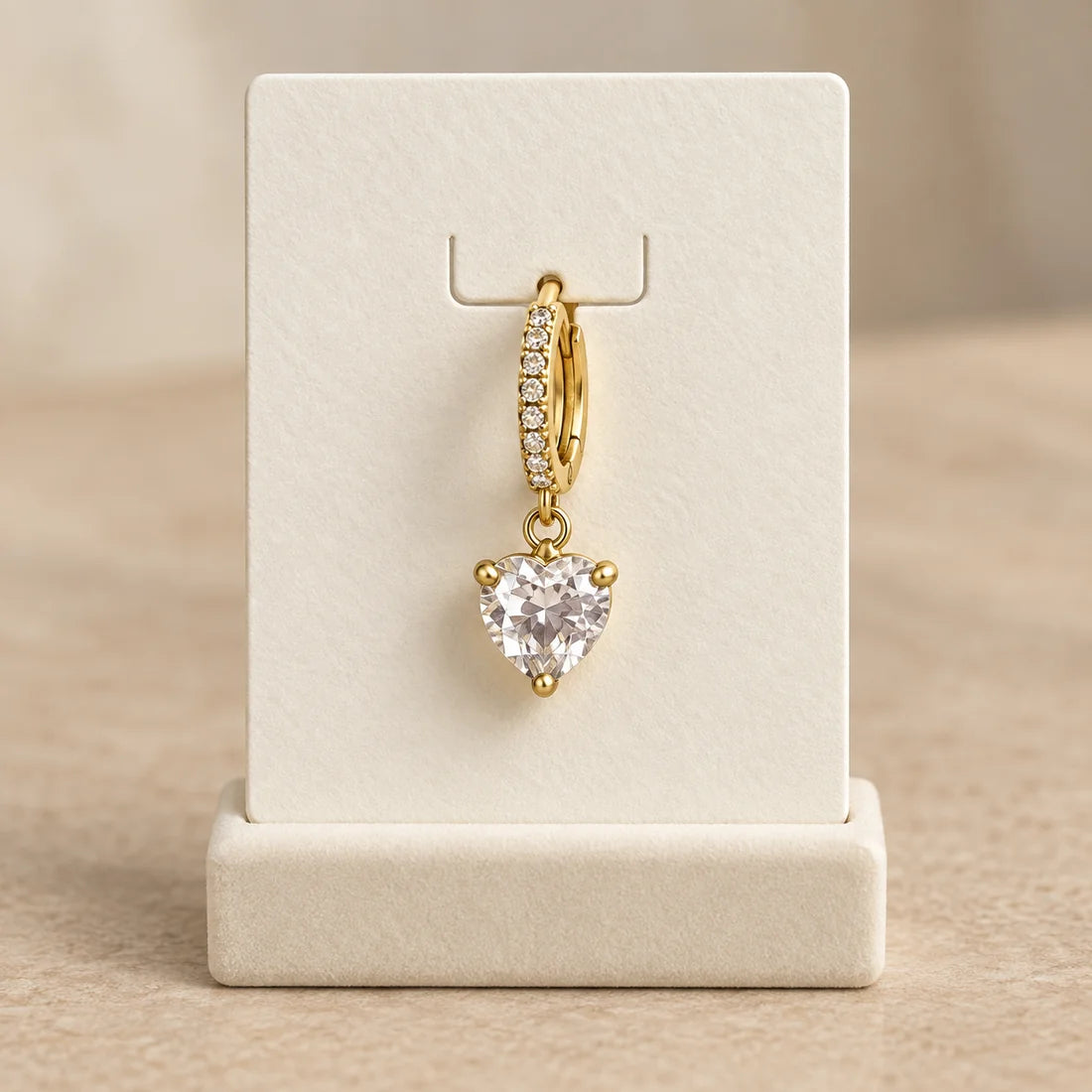 Crystal Heart Piercing displayed on an ivory jewelry card