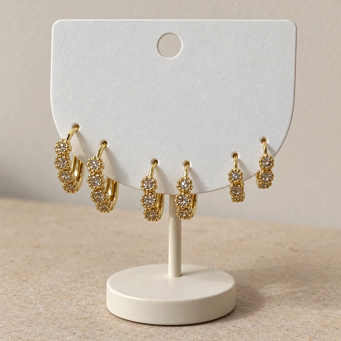 Crystal Rosette Hoops Set displayed on an ivory jewelry card