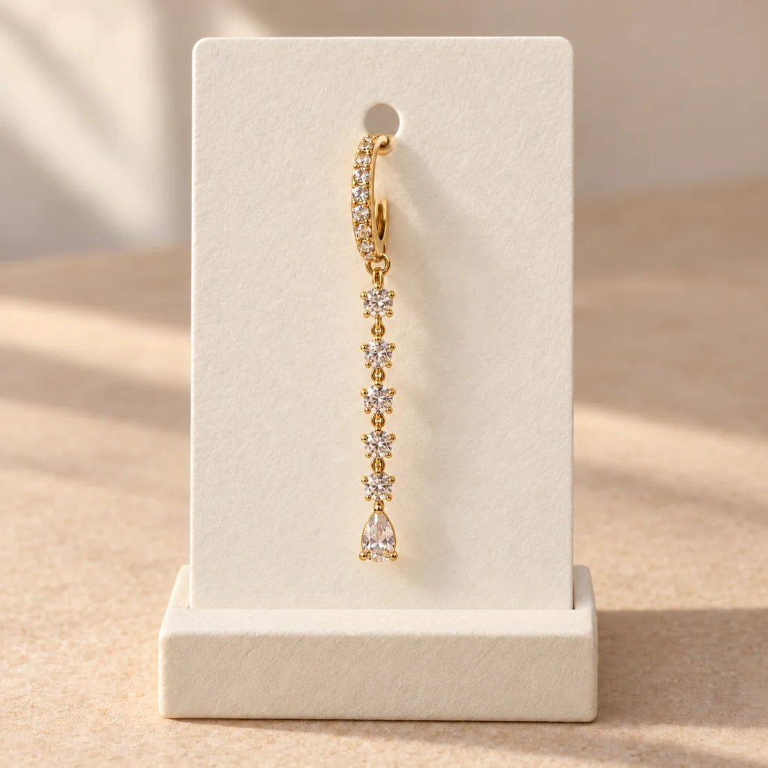 Crystal Stream Piercing displayed on an ivory jewelry card