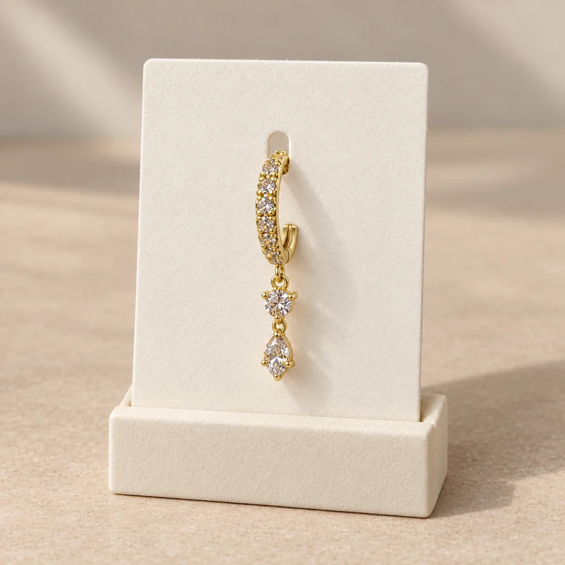 Dewdrop Duo Piercing displayed on an ivory jewelry card