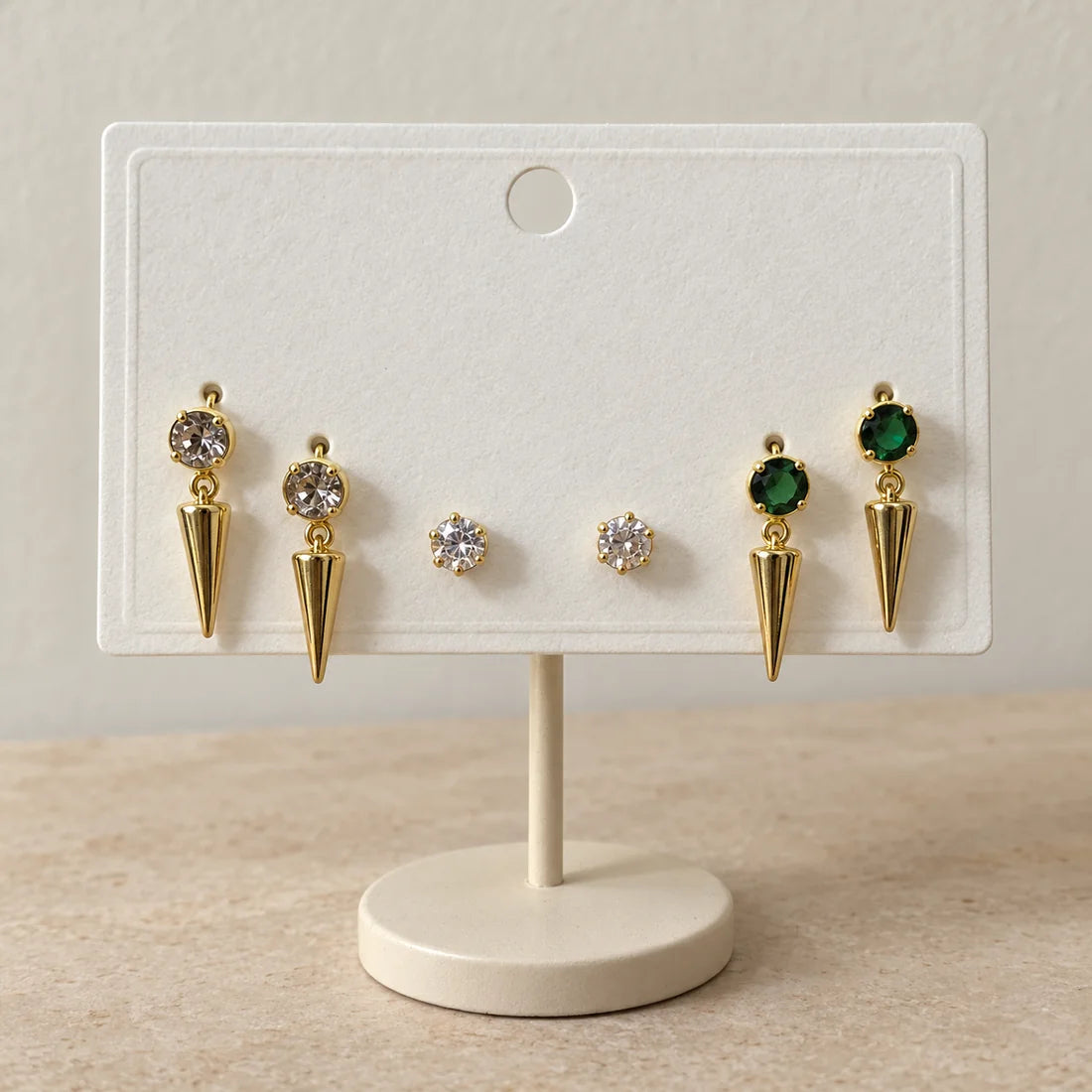 Emerald Spike Stud Set displayed on an ivory jewelry card