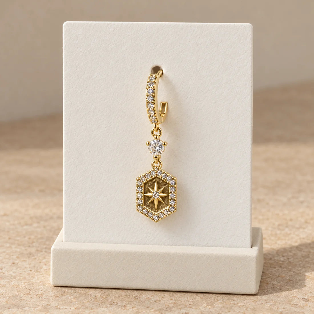 Golden Compass Piercing displayed on an ivory jewelry card