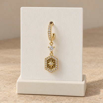 Golden Compass Piercing displayed on an ivory jewelry card
