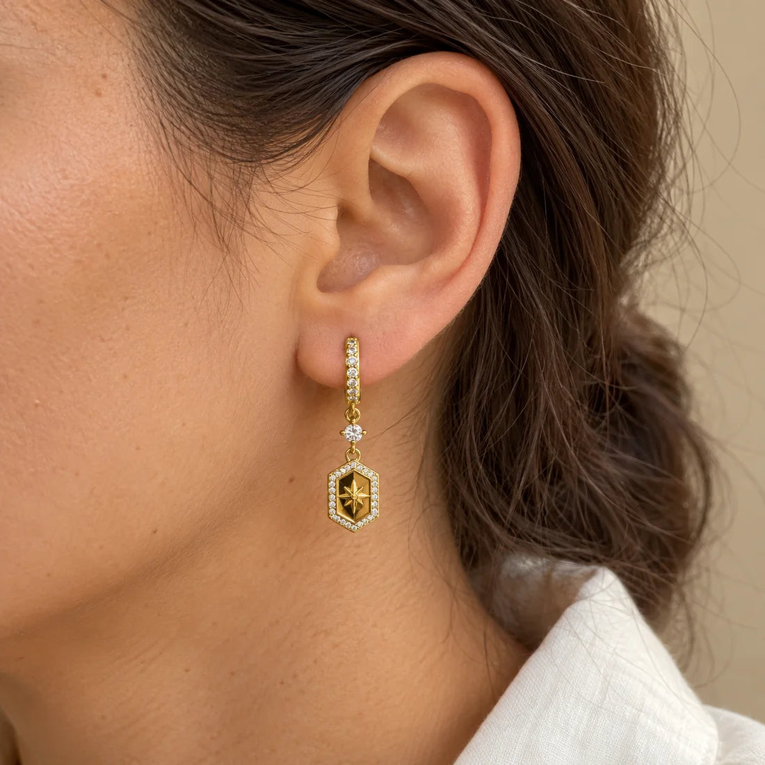 Golden Compass Piercing worn on an adult model ear