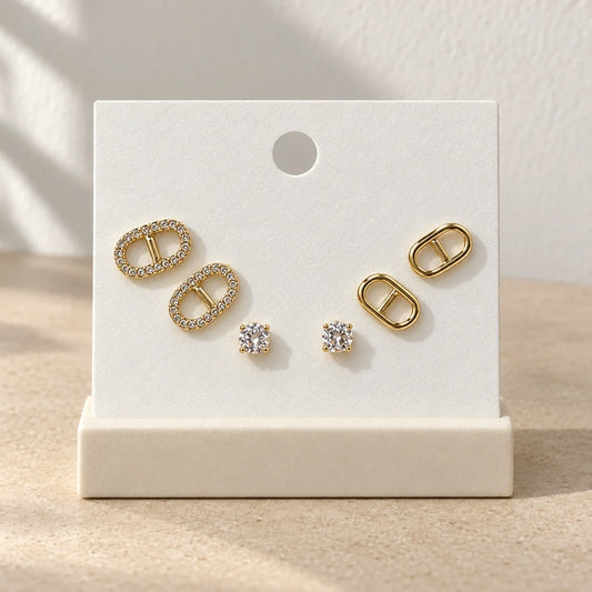 Golden Link Stud Set displayed on an ivory jewelry card