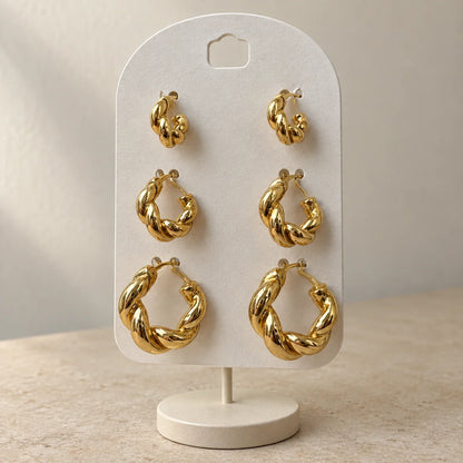 Golden Twist Hoops Set displayed on an ivory jewelry card