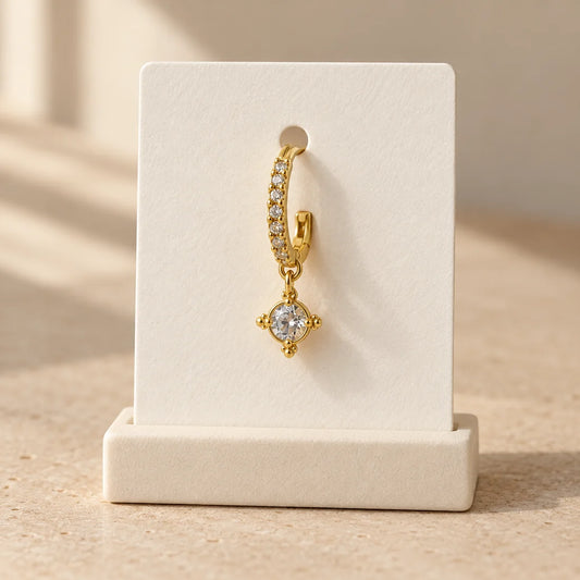 Solar Halo Piercing displayed on an ivory jewelry card