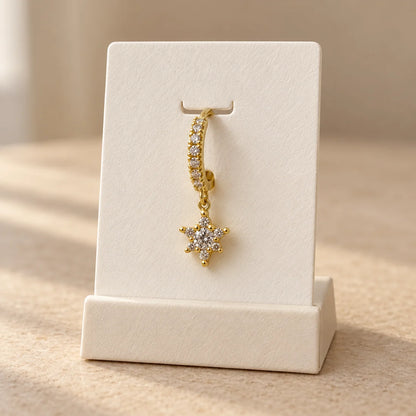 Starburst Hoop Piercing displayed on an ivory jewelry card