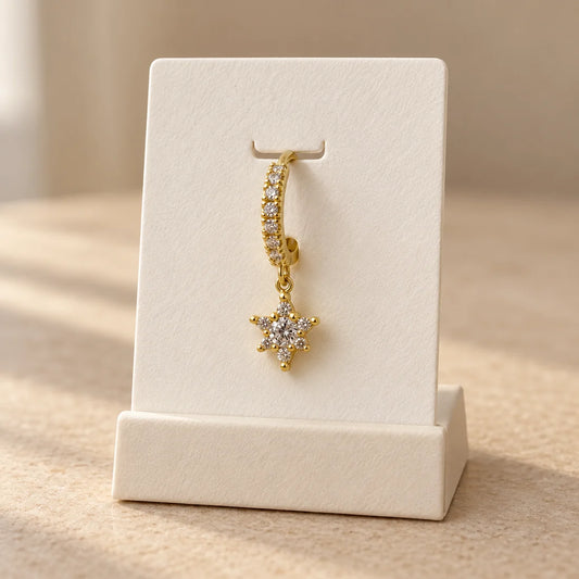 Starburst Hoop Piercing displayed on an ivory jewelry card