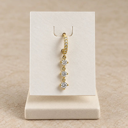 Triple Sparkle Piercing displayed on an ivory jewelry card