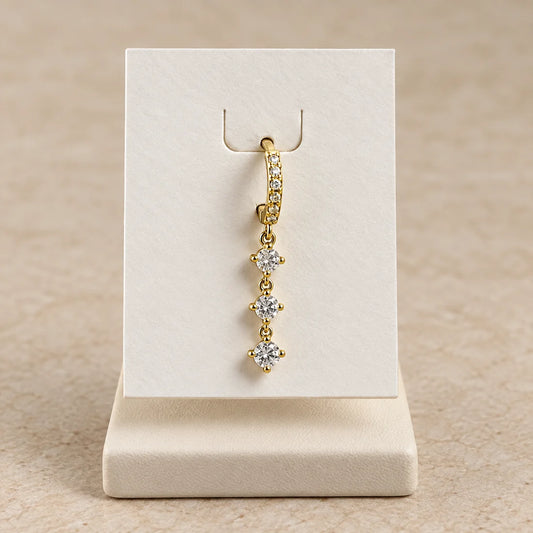 Triple Sparkle Piercing displayed on an ivory jewelry card