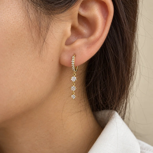 Triple Sparkle Piercing worn on an adult model ear
